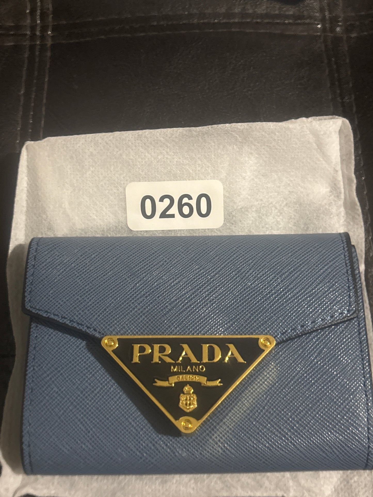 Prada Milano inspired cornflower blue Saffiano textured faux leather compact wallet with gold triangle Prada Milano logo plaque and envelope flap closure with dust bag item 0260